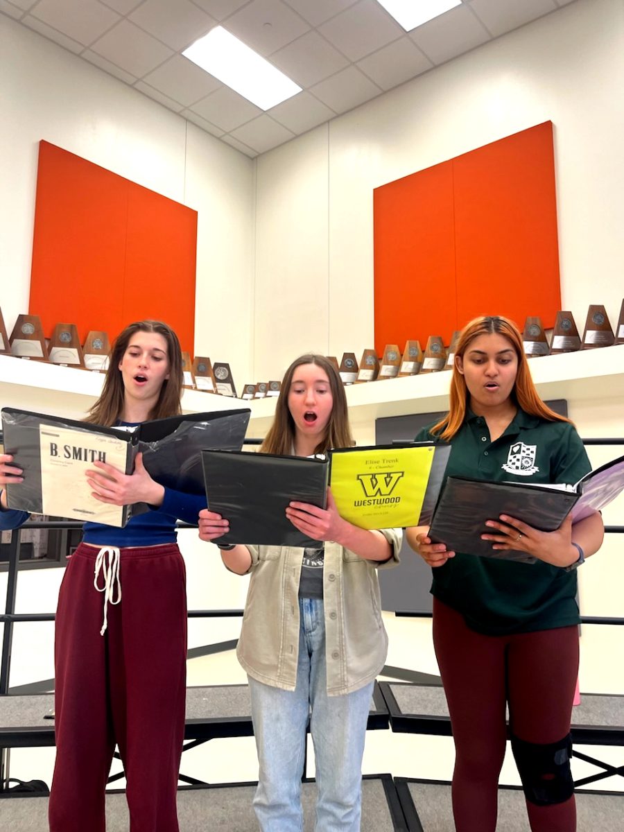 Leading the group in musical practices, choir presidents Kayla Contello 24, Annika Iyer 24, and Elise Trenk 24 stand together singing. With strong ties to music, the presidents weaved their passion for choir with their creative leadership to foster a supportive and talented choral community. My goal is always about making this the best memory it can be for everyone involved, Trenk said. I want my personal legacy to have [created] a community built around making choir fun and a safe space for all of us. 