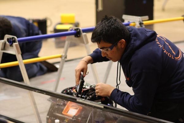 With attention to detail, Jatin Aggarwal 26 inserts a battery. At this competition, Tomahawk won the Design Award for their robots functional and aesthetic design.