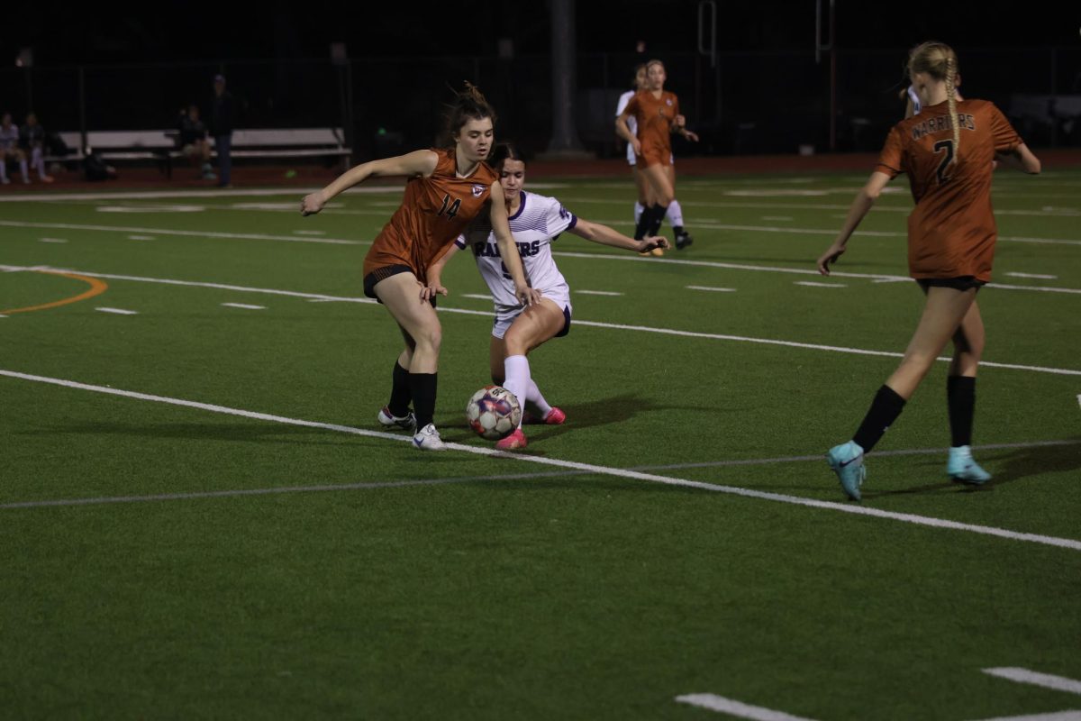 Lunging towards the ball, Audrey Savoie 26 wards off the Raiders player from maneuvering past the Lady Warriors defense. Throughout the game, there were multiple one on one battles which contributed to the overall win for Westwood.
