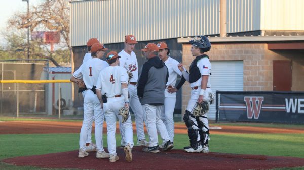 During the first inning, the infielders gather around Coach Casey Carter for a mound visit. The infield struggled throughout the game, failing to catch the ball several times, which allowed Cedar Ridge to consistently advance bases. 