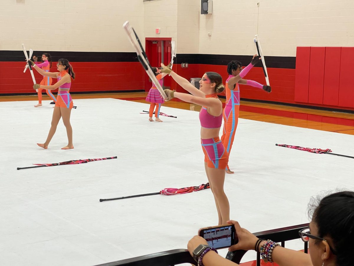 Captain Keira Humphries 24 practices rifle choreography during equipment warm up right before the color guards performance at WGI San Antonio. They placed 12th in both prelims and finals.