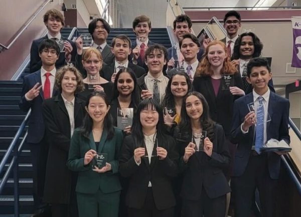 Posing for a photo along with other debaters, Anushka Gupta 26 smiles with her trophy. One of three sophomores invited to this prestigious debate tournament, Gupta advanced to the semi-finals of the competition. 