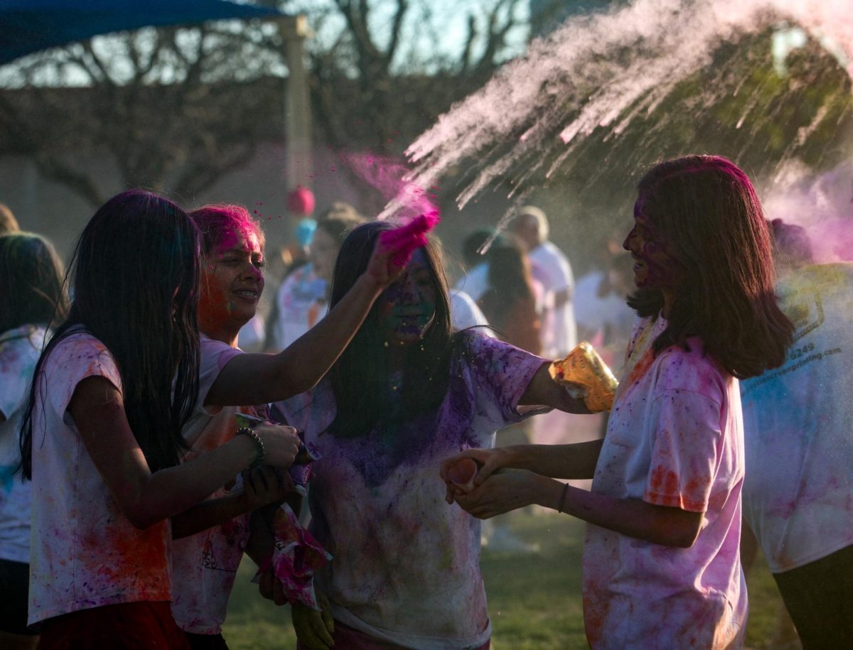 Celebrating with her friends, Aanya Ujjval 26 gets sprayed with color powder. All profits from the Holi festival through selling powder and shirts were donated to Casa Marianella.