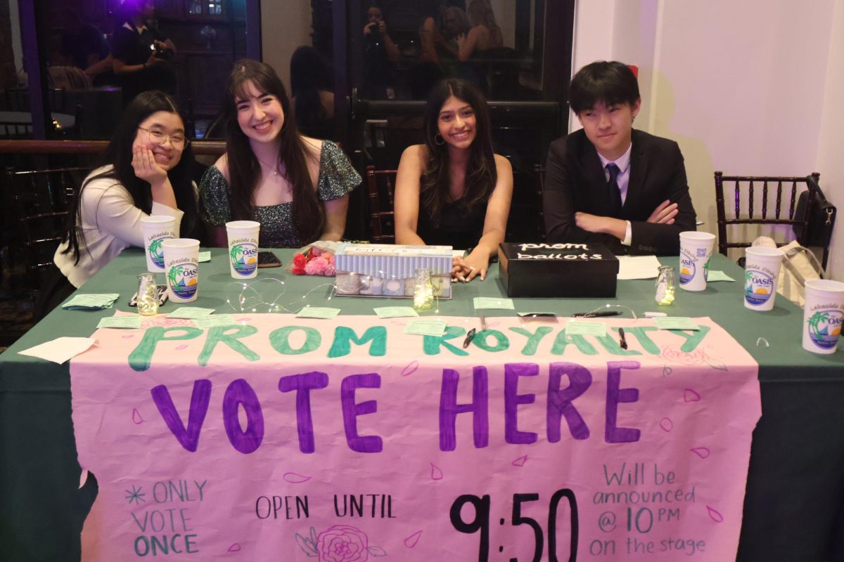 Observing the evening festivities, English teacher Samantha Lozano and Student Council officers Iris Chen ‘26, Rheya Kurian ‘26, and Aiden Wen ‘26 sit behind a prom court voting booth. The booth was open right until the prom king and queen were announced, allowing students to cast their votes throughout the night.