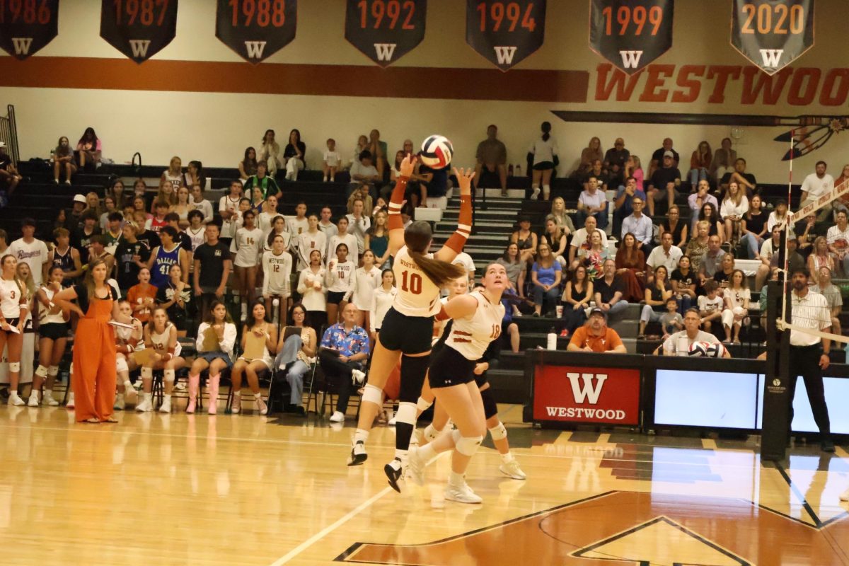 Soaring, Lila Wellingtin '27 hits a volleyball in the air during the first set of the home game against Vandegrift High School on Tuesday, Aug. 27. Westwood fought a hard game but ultimately lost the first set of the game 11-25.