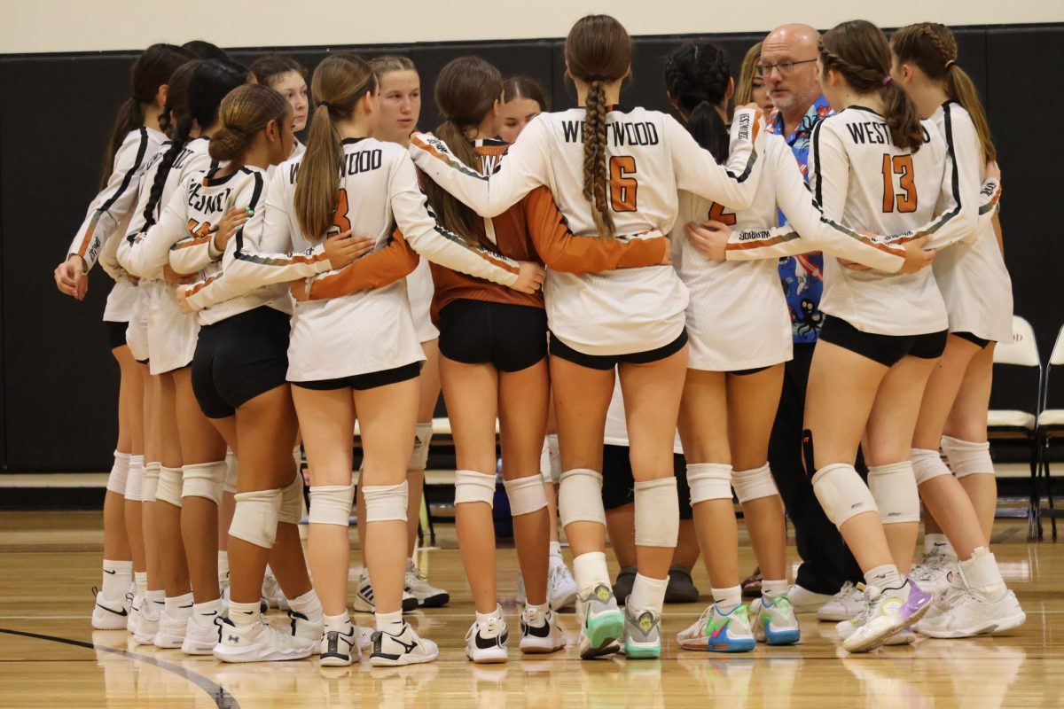 Players huddle after getting down in the second set. Even as the Warriors got down on points during the game, the timeout helped them regroup and continue playing their best ultimately ending in a win.