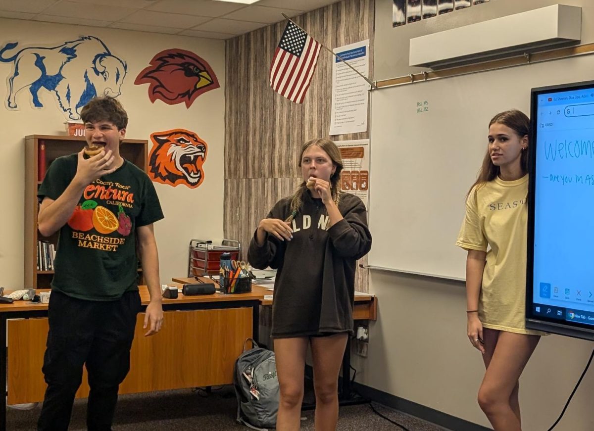 Enjoying their donuts, ASL Club officers end their first meeting of the year. Spending time learning new hand-signs and encouraging bonding among members, the officers fulfilled their goal of generating interest in new members. 