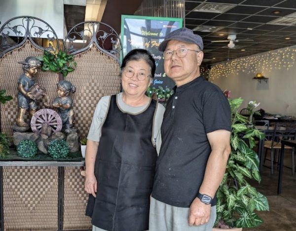 Standing in front of the restaurant’s entrance, co-owners Mrs. Jae-Kyung Kim and Mr. Kiho Kim pose together in the Fresh Heim Steak & Salad restaurant. After immigrating from Korea, the married couple took ownership of the restaurant and integrated an Asian twist on the classic American menu.