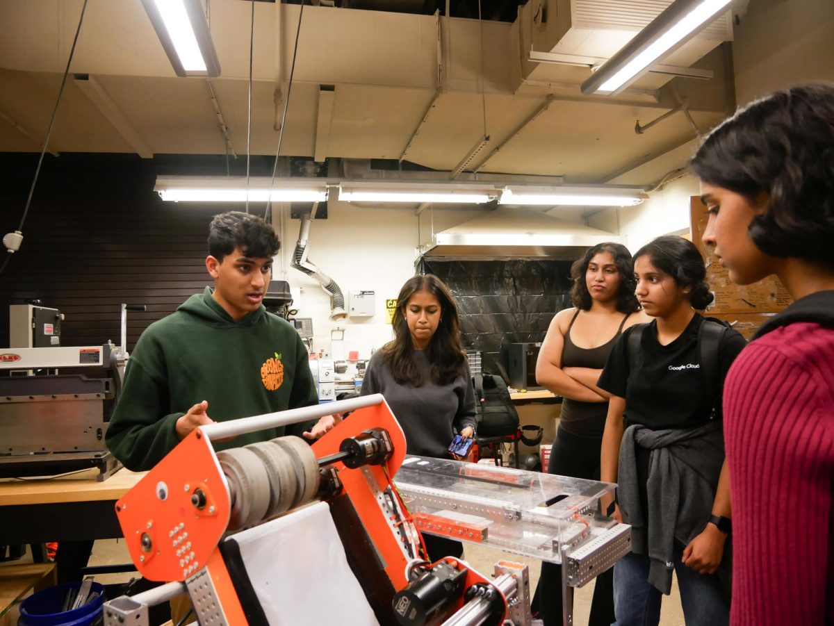 Gesturing at a mechanism, Adam Menezes ‘25 explains Orange Dynamite’s off-season robot, nicknamed “Kiwi,” to prospective club members. The FRC team held a separate session after the general information session, where they delved deeper into robotics concepts specific to FRC for members interested in joining.