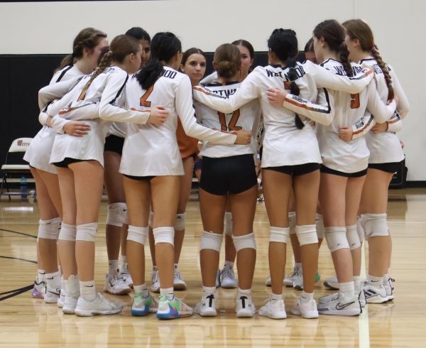 Huddling together, the Warriors regroup to try and get out of their point deficit early on in the first set. The Warriors beat the McNeil Mavericks on Friday, Sept. 13 ending the game in a clean sweep, communicating even as they were down. "I think the team recovered after a good pep talk from the coach," Lucy Aldrete '28 said.