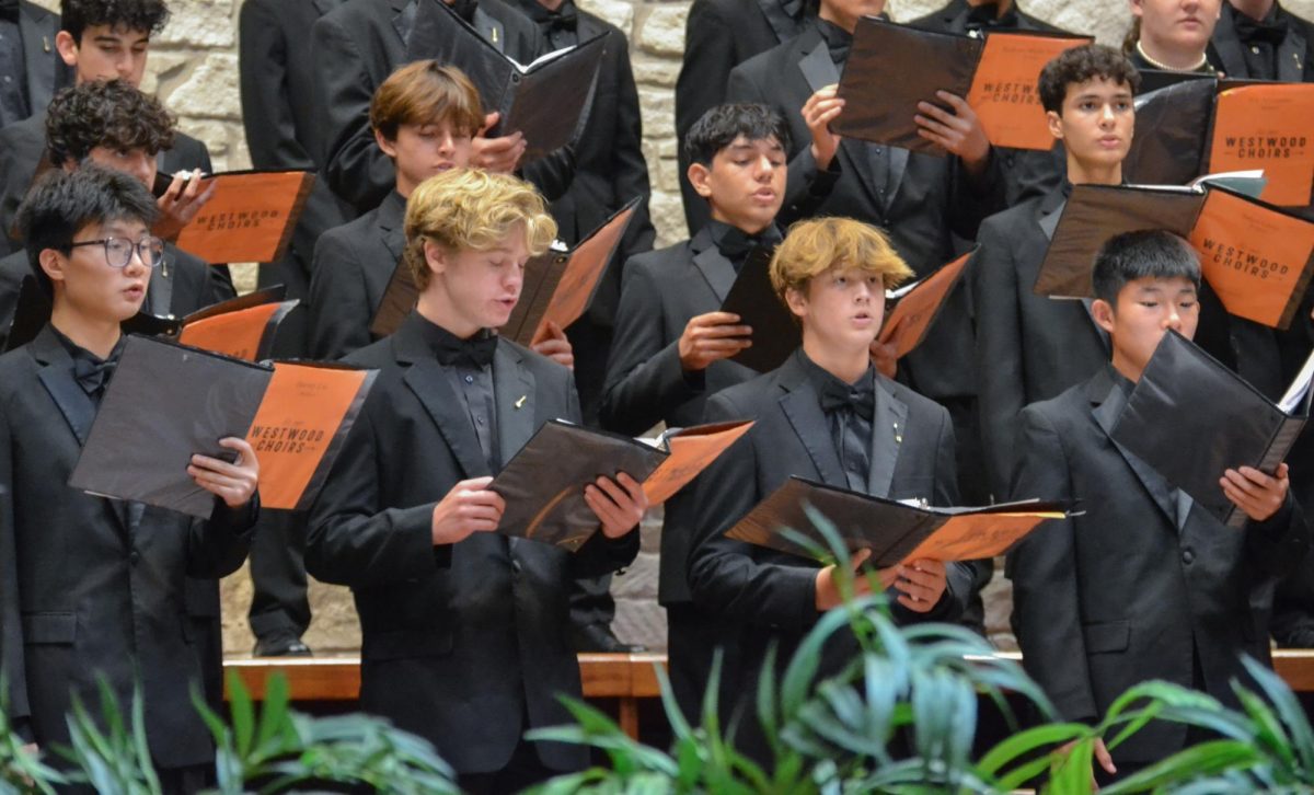 Sheet music in their hands, Bellator choir performs during the Fall Concert. Throughout the concert, each section was able to demonstrate the hard work that they've put into the choir thus far. 