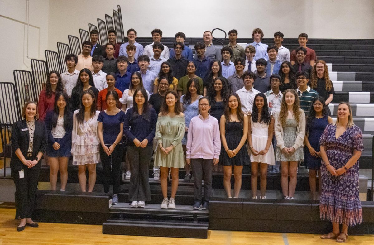 The 52 National Merit Semifinalists stand with Principal Erin Campbell and Lead Counselor Holly Browning for a photo. 