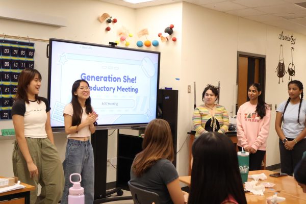 Standing at the forefront of the room, GenShe Vice President Natalie Ju '26, President Josephine Sun '26, Secrectary and StuCo Rep Ariana Fresques '26, Director of Operations Samhita Nagarakanti '26, and Director of Marketing Samymy Gorapalli '25 (from left) present an informational slideshow about GenShe. GenShe officers presented a general club overview while members made inspirational bracelets.