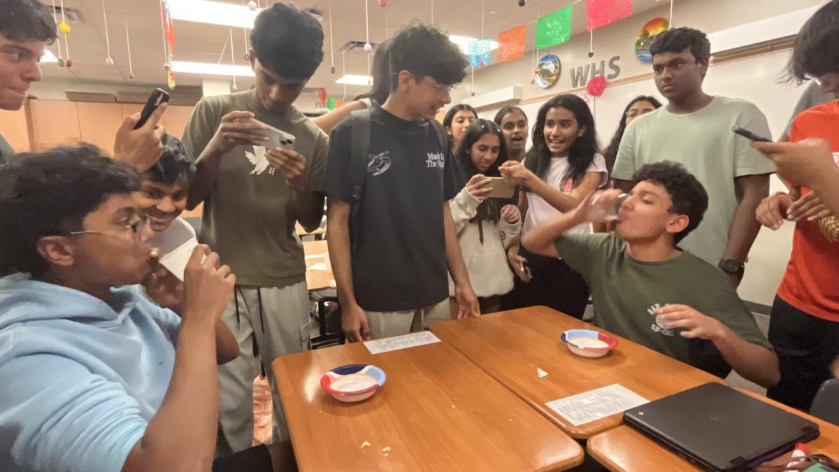 Racing to finish first, Sai Anumakonda '27 and Adwik Rath '28 eat their pani puris as fast as possible. Rath '28 eventually won, and continued to the next round to win the Pani Puri Competition. 