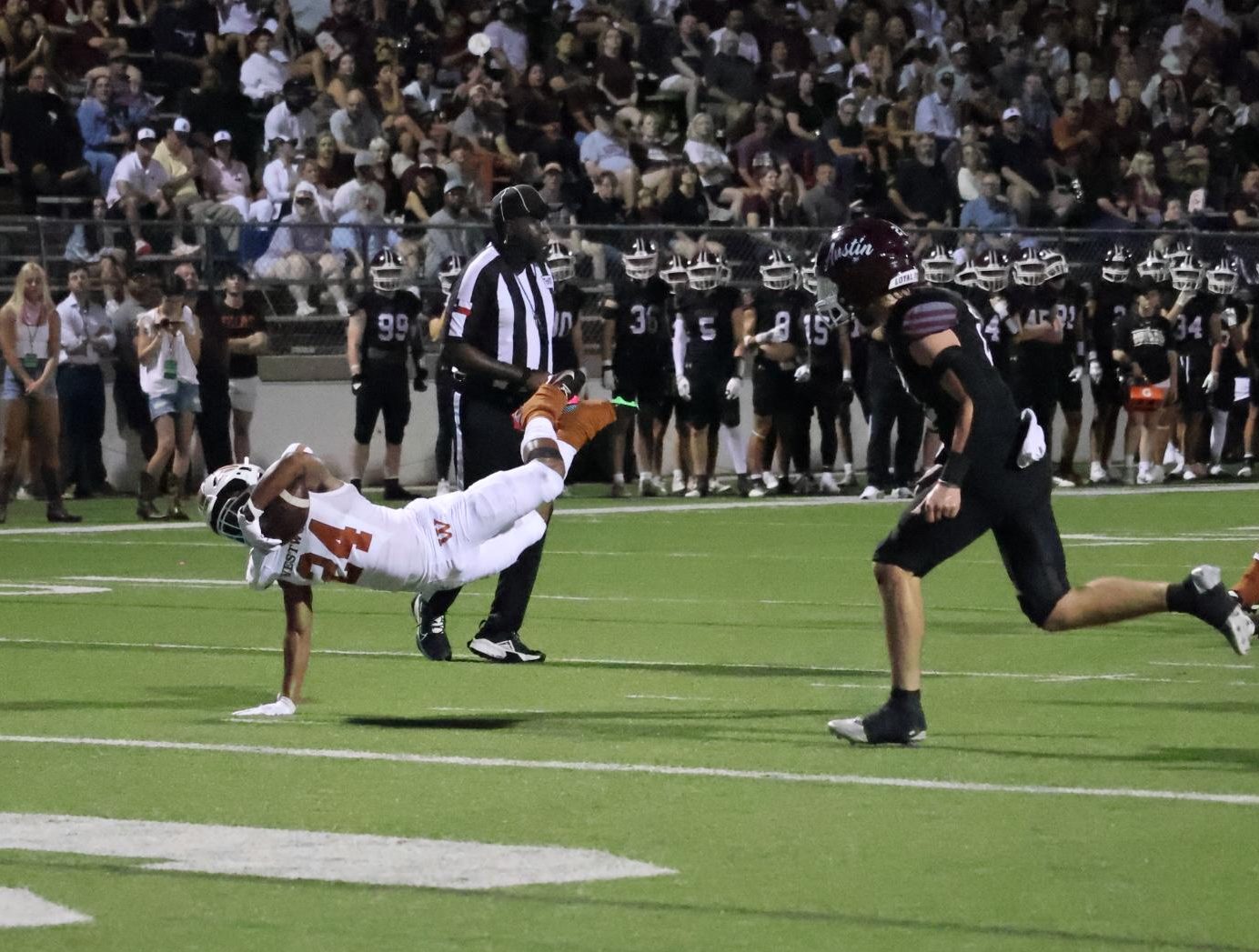 Diving into the endzone to put the Warriors ahead of the Austin High Maroons, Xavion Sutton '25 leaps past the pylons scoring once again. As the back up running back the year before, Sutton looked to propel his offense forward. "You can't be reliant upon one player like we were last year," Coach Anthony Wood said. "We have been getting this group to where it is not just one guy, we've got six weapons ready to give their all."