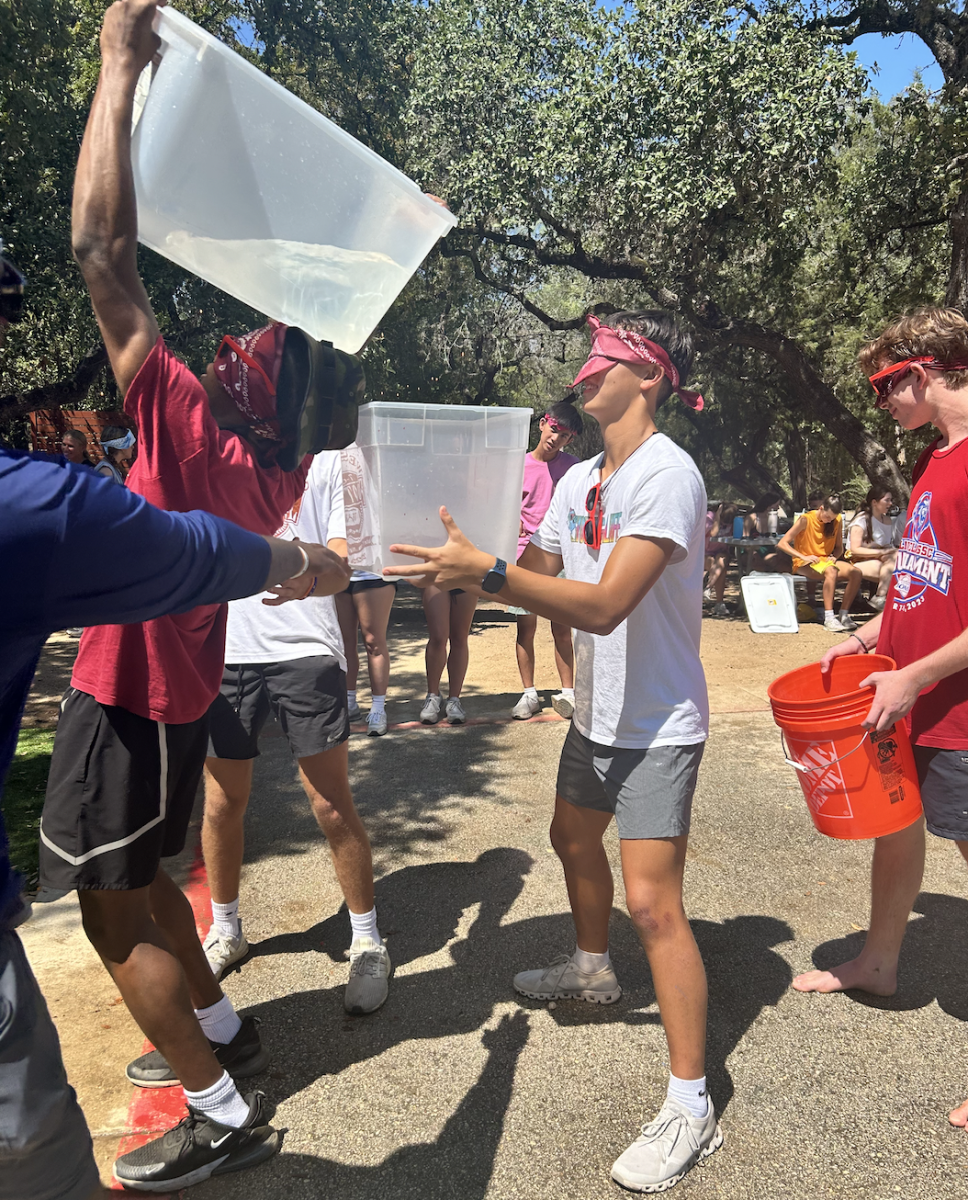 Waiting with anticipation, Asher David '26 eagerly stands to receive water from Tyson Woods '25, in attempts to catch all of it blindfolded. As a new PAL, David engaged in multiple rounds of meticulous team bonding games with his newly revealed campus, competing against all the other teams. "There's a lot of people on my campus who I don't know outside of PALS, and I really got to know," David said. "I got introduced to them, so I'd say yeah, that's [pretty] cool."