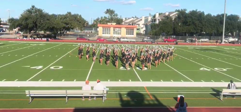 In formation on the field, Warrior Pride members celebrate their first performance of the season. 