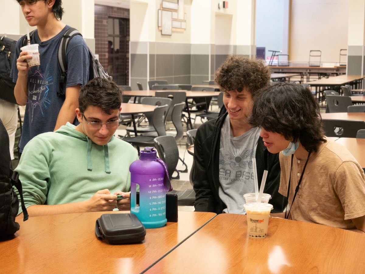 Playing a video game, Robotics Club members Ilia Iliev ‘26, Scott Sundstrom ‘25, and Samuel Yarbrough ‘25 enjoy their drinks. Many robotics members got the chance to meet students on teams other than their own, strengthening the community within the club as a whole.