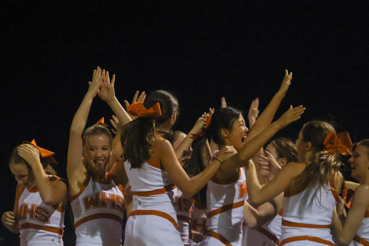 Cheering, the cheer team celebrates their first place win for their Homecoming float decoration. The announcement for the winners, which was made after the pep rally, energized the cheerleaders. 