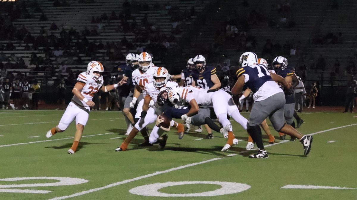 Laying out the Stony Point quarterback on Friday, Oct. 25, Kye Bridges '26 and the Westwood defensive line break through the offensive line, forcing a punt and ending the Tigers' drive at the end of the second quarter. Down by 11 at halftime, the Warriors looked to end Stony Point's hopes of a win and take the lead. "We were moving the ball pretty well on offense [going into halftime]" Colten Case '26 said. "We just couldn't keep it going after that."