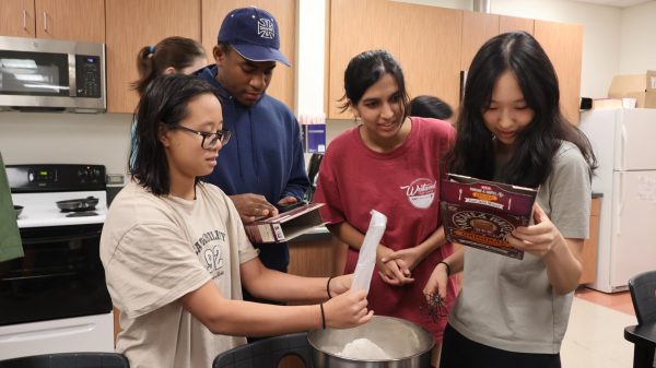 Gathered around the ingredients, Oprah Wei '26, Ryan Linton '25, Siyona Jain '25, and Allison Yao '25 work together to make batter. This was the first step in preparing the batches of pancakes for the teachers. 