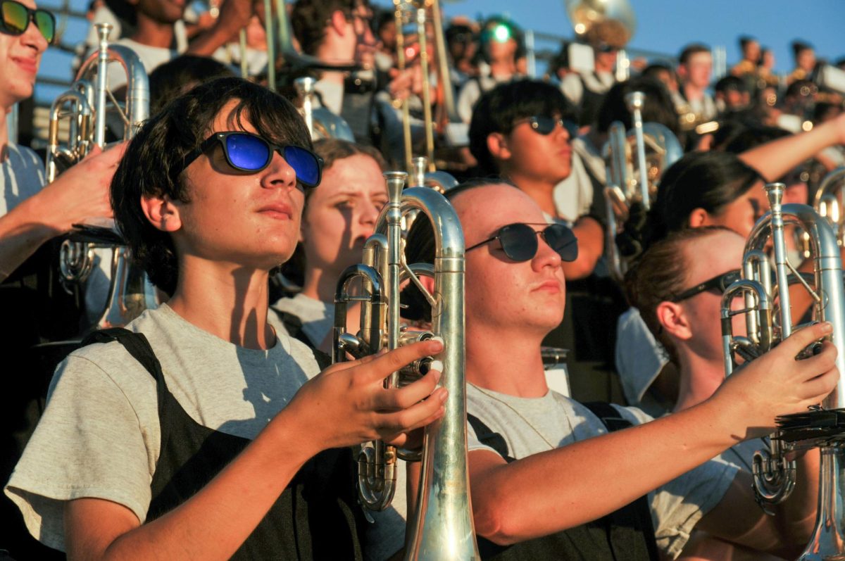 Awaiting the count in, Keiran Beltran '26 holds his mellophone at set. In the stands, the band has many traditions ranging from vocals to choreography.