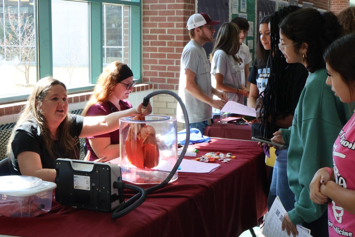 Paying attention to the heart simulator model, HOSA members learn about various healthcare programs at the college and career fair. The fair was part of the larger Fall Leadership Conference, an event that allowed for unique learning and networking opportunities for the wider HOSA community. 