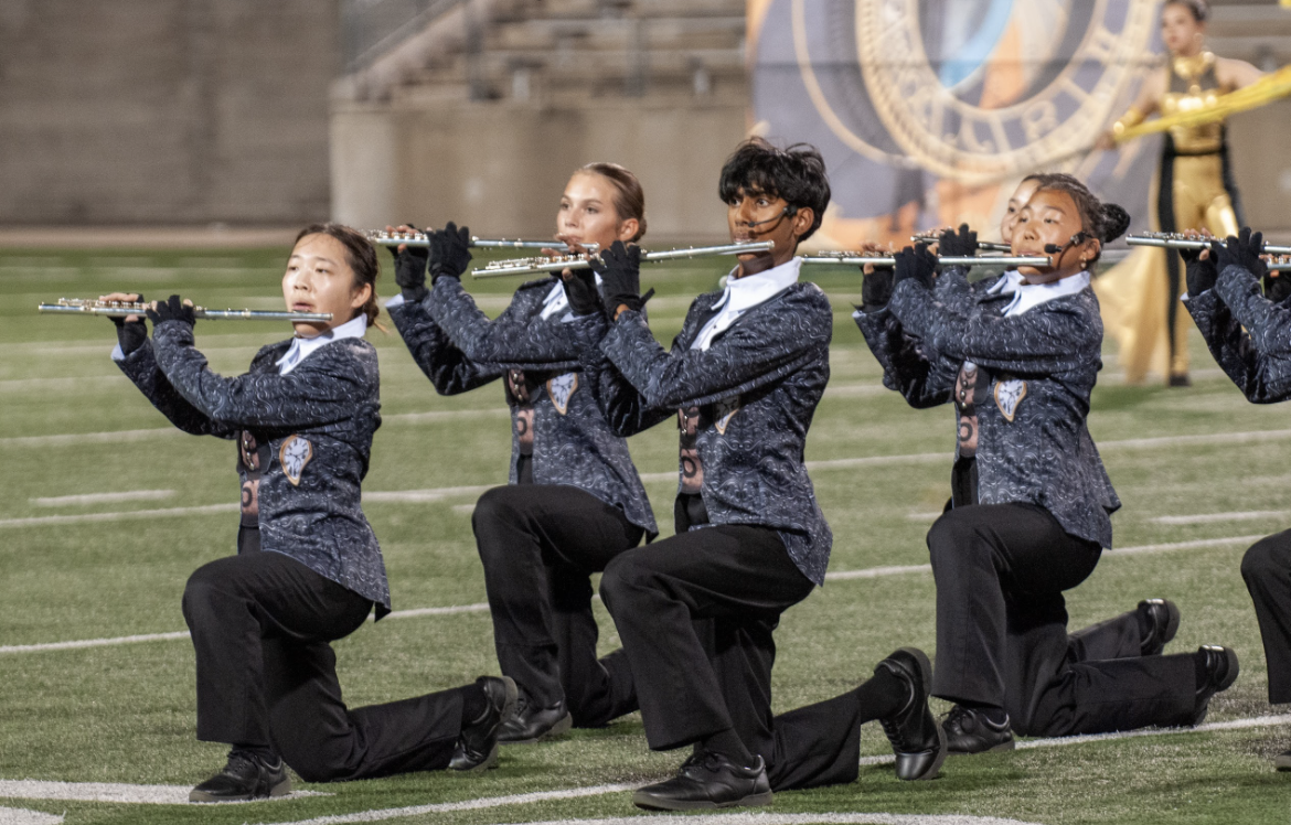 Posing in a kneel, Rachel Zhu '26, Julia Gray '28, Pio Antony '27, and Soomin Oh '27 play a difficult part of their music. The band had roughly a week to pull together some of the hardest parts of their show to be ready in time for TMC.