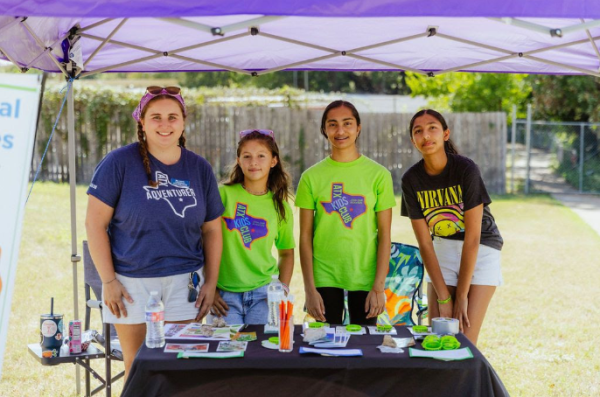 Smiling brightly at a fundraiser, Ms. Linnie LaMaster stands with her teen volunteers for ATX Kids Club. Ms. LaMaster emphasizes how important fundraising is when running a non-profit. “People don’t think about how expensive it can be to run a camp. We rely a lot on fundraising and donors so we can continue to give it back to the kids,” Ms. LaMaster said.