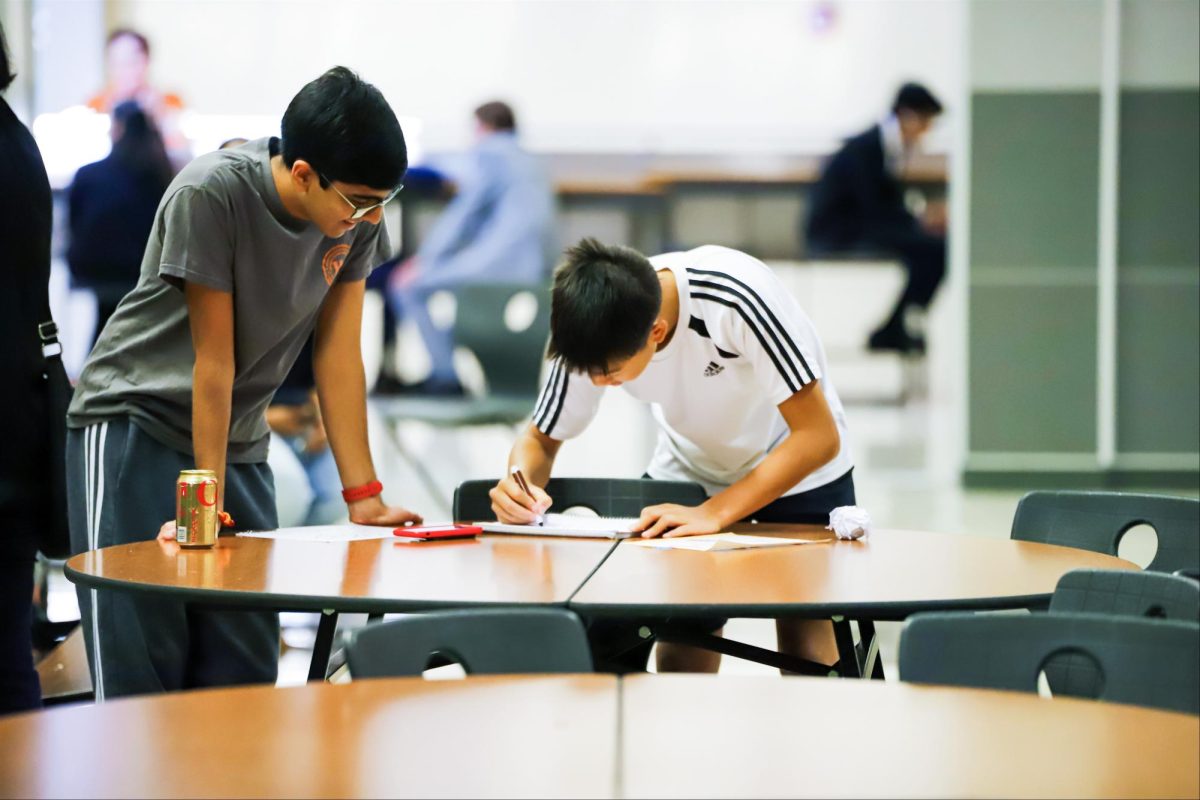 Preparing new signs and posters for the tournament, Ethan Chen '27 and Amogh Badrayani '25 draw out careful directions for competition locations. The Westwood Bowl was run by student volunteers who helped from early morning to late in the night. 