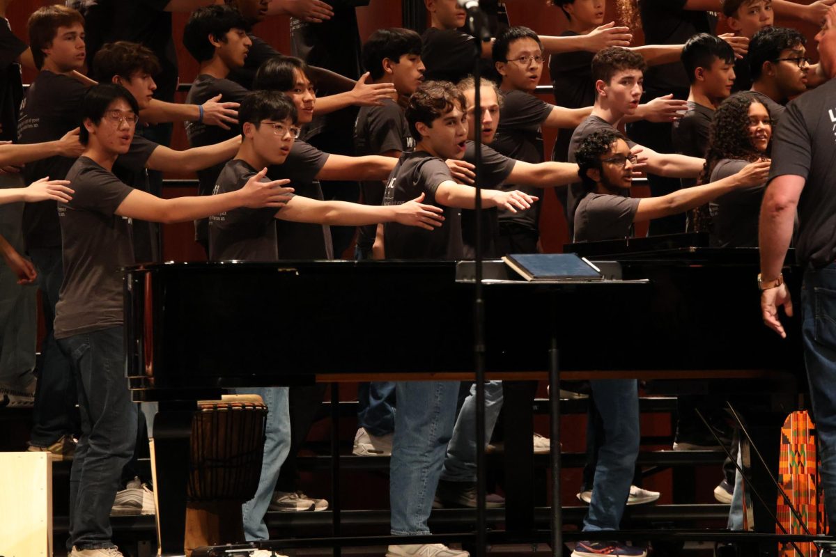 Arms outstretched, the tenor and bass sections of the choir perform "Bonk' Abaphandle," the final piece performed exclusively by Westwood singers. The song's theme of welcoming was designed to serve as a welcome to "The Tribe" for younger learning communities.