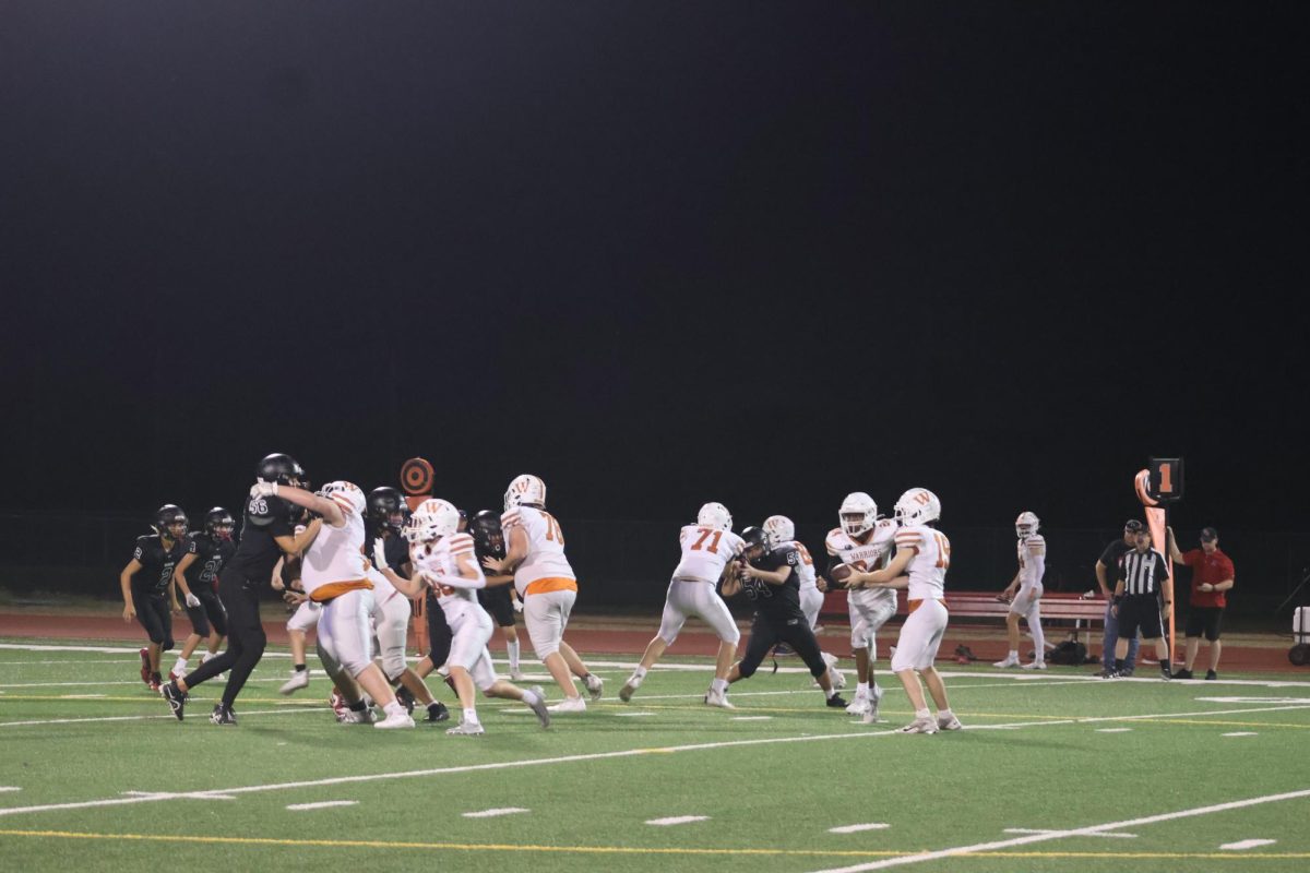 While the Rangers are distracted, William Chuck '28 hands the ball over to his teammate for a run to gain yards. "[This game I really wanted to just] win the game and have fun,".