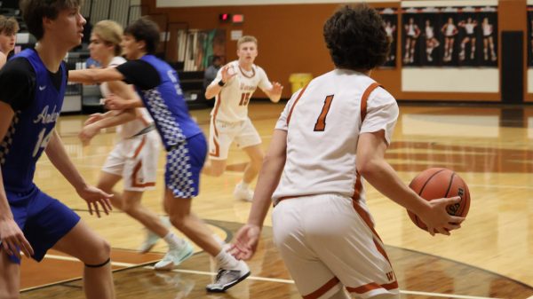 Dribbling near the basket, John McNair '26 prepares to pass the ball to his teammate, Thomas Burke '25. McNair had a great game, commanding the ball through a lot of the second half.