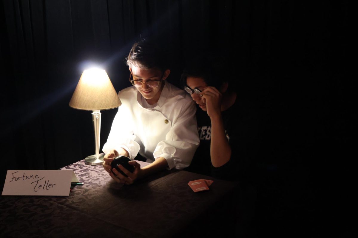 Gazing into a magic eight ball, seniors Connor Wormington and Vince Pham participate in the fortune teller station set up in the Black Box. Aside from the haunted house, officers also planned stations to be happening concurrently so everyone would stay entertained. 