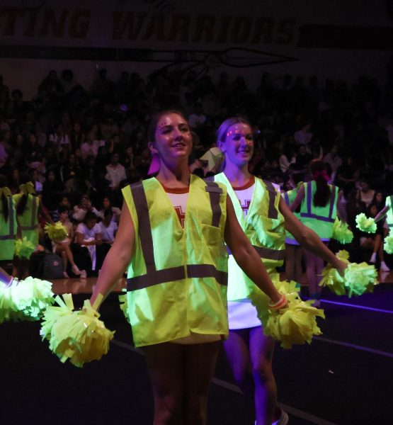 Decked out with neon clothing, the cheerleaders energize the crowd. Cheer was one of the first performances to be spotlighted during the pep rally.