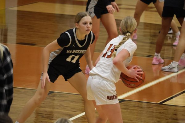 Face-to-face with an opponent, Co-Captain Theresa Bell '26 prepares to pass the ball. Bell discussed the importance of strengthening the team's defense and offense. "Offense is really important, making sure we knock down shots," Bell said.