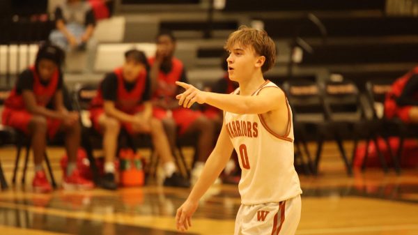 Guiding his team, Charlie King' 27 helps the offense get in formation. “I was directing the offense," and "Someone was having trouble getting into their position so I was trying to help them out so we could score a bucket.” King said.
