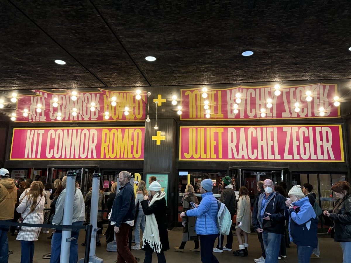 As a line starts to form, the anticipation of the audience starts to grow as well. With signs above their heads, this bold and vibrant text is their first taste of what is still to come. 