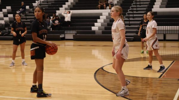 Evelyn Bell '27 prepares to charge for the ball against the Hutto Hippos on Friday, Dec. 13. The Warriors went on to dominate the rest of the game, turning a two point deficit much larger.