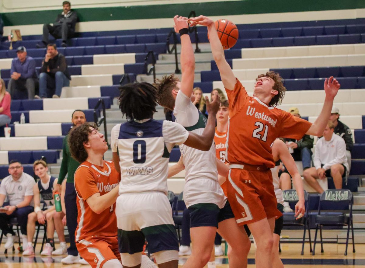 Leaping into the air, Boys Basketball Captain Indy McBrearty '25 fights with a Maverick for control of the ball. The team's intense offensive play and impressive defense helped them secure a sweeping win. 