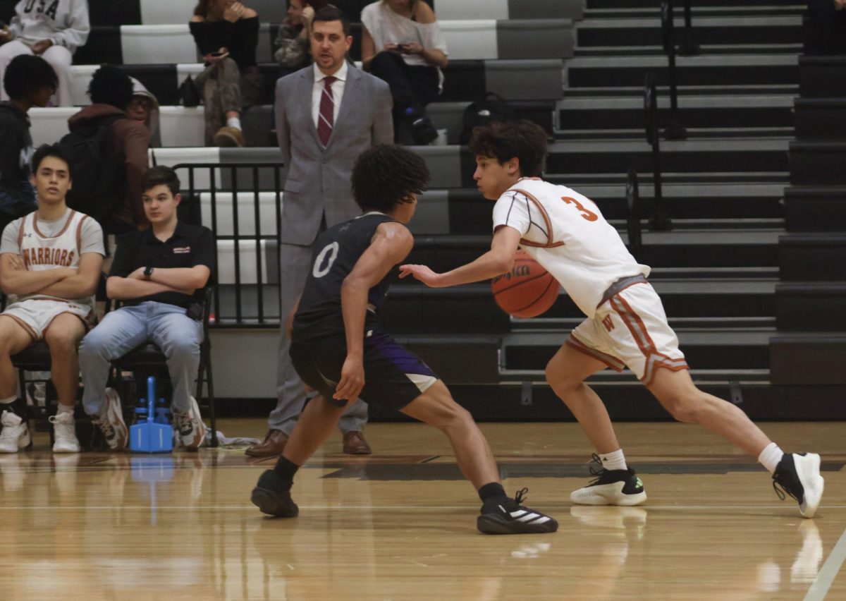 Running the ball down the court, Joseph Bibbo '27 looks for an open teammate to pass the ball to. 