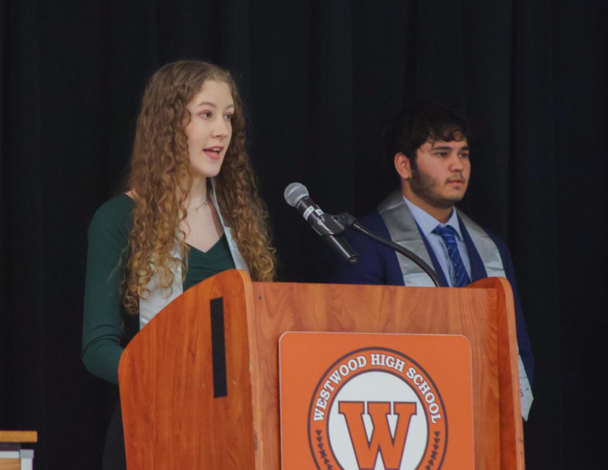 On stage, Jody Gaffney '25 addresses the inductees. Each officer approached the podium to speak to the attending NTHS members. 