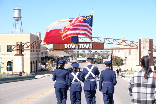 Leading the march to downtown Round Rock, the Hutto High School ROTC Color Guard stands tall, proudly displaying the Texas and American flags. Their ceremonial presence sets a tone of honor and pride, as the community rallies behind them, united in purpose and spirit.