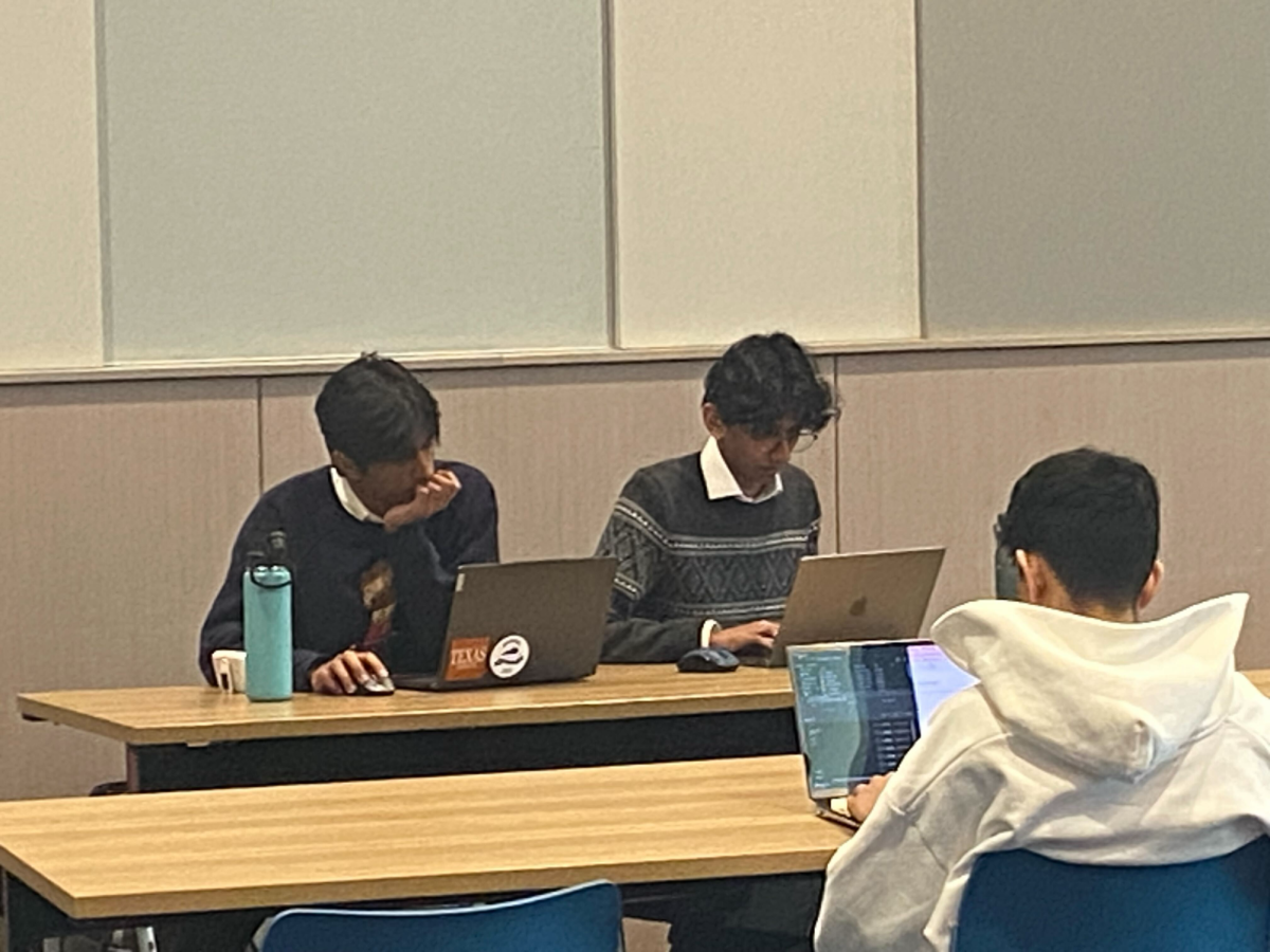 Rapidly typing on their computers, Pranav Balakrishnan '25 and Ethan Andrew '26 finalize their rebuttal speech at the University of Emory's elimination rounds. After two days of fierce competition, the team knew that this win could help propel them to the final round of the tournament. 