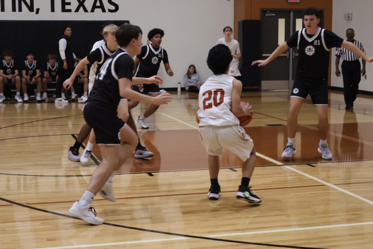 Bryan Li '28 attempts a two-point shot. The Warriors gained a lead at the beginning of the match, but quickly lost it.