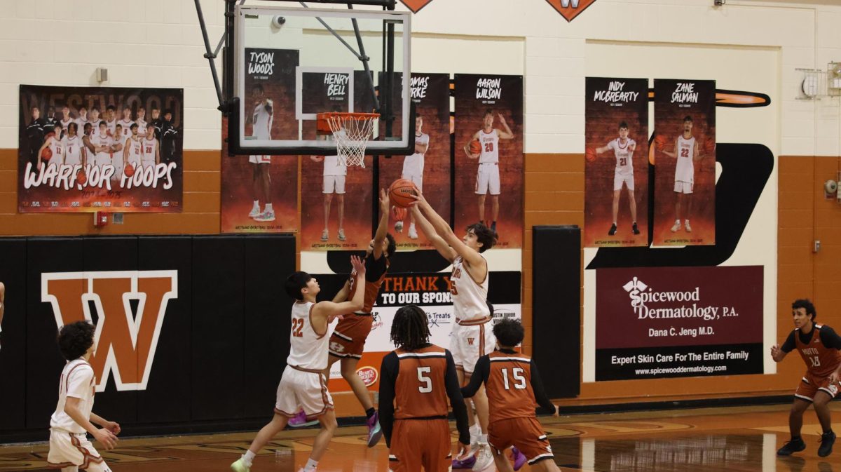 Beneath the basket, Evan Richards '27 grabs another rebound. Richards' perfect timing allowed him to rise above his opponents to grab rebounds. 