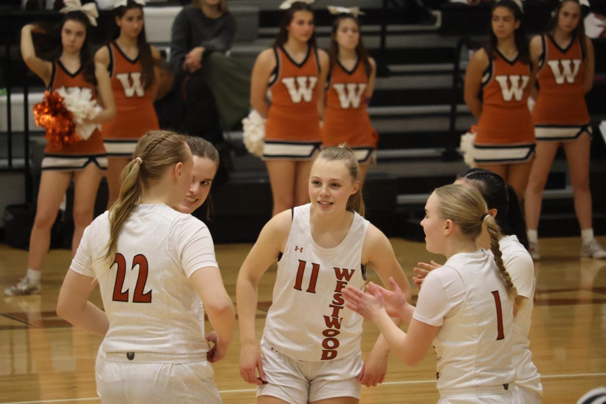 In a circle, the starting players strategize before the game. The team utilized multiple time-outs to discuss their strategy throughout the game.