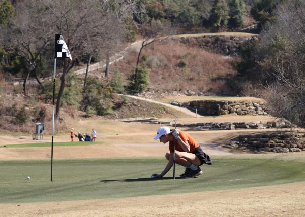 In the middle of the hilly course, Lauren Phelan '25 sets her ball on the green. Great Hills Country Club is Phelan's home course, which gave her an advantage during the tournament. "It has a lot of different and curvy holes, as well as a lot of water features and hills," Phelan said. "It’s quite a beautiful course to play."