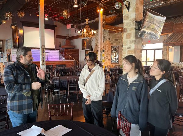 Listening intently to the guide at the Oasis, junior class Student Council officers scout the restaurant for placement of Prom activities. The officers spent hours both on-site and on campus to ensure a seamless and memorable event. 