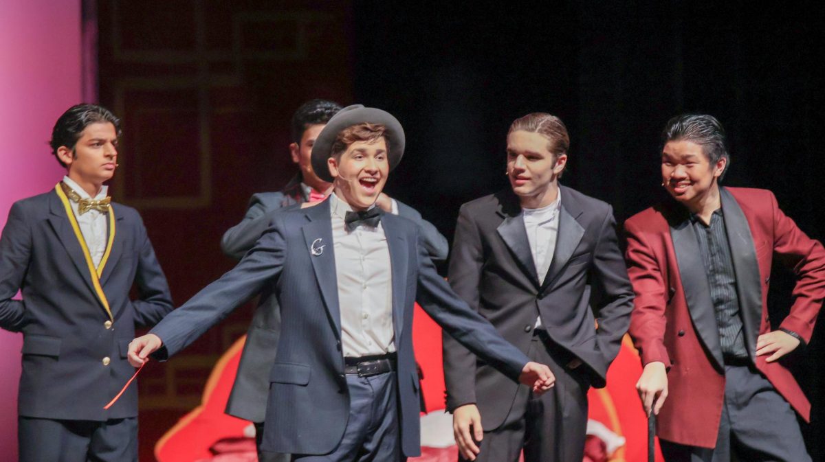 As the remainder of the principal male characters look on, Browning Lind '25 performs as neurotic best man George. Over his three years in the musical theater program, Lind honed skills that culminated in his performance as George.